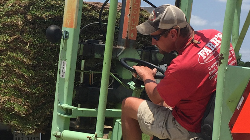 Image of Farr's Landscape Supply & Sod employee on forklift with pallette of sod